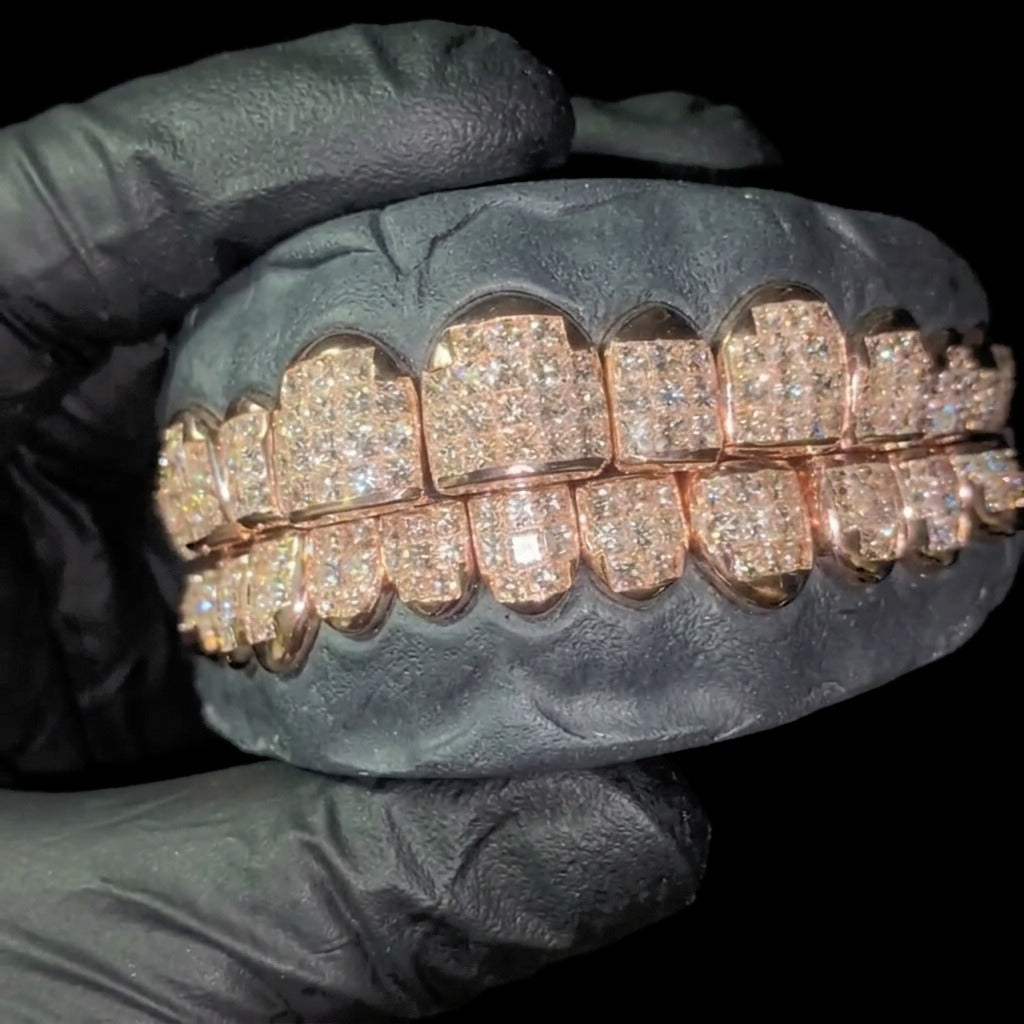 Close view of rose gold moissanite grillz pave detail on dark dental mold