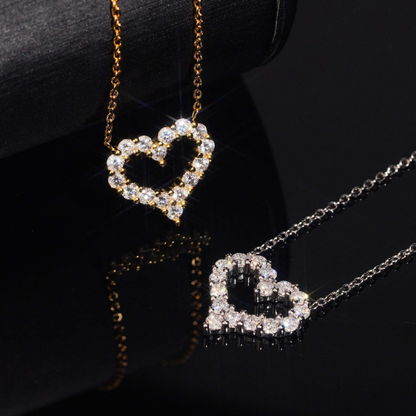 Gold and silver moissanite heart pendants side by side