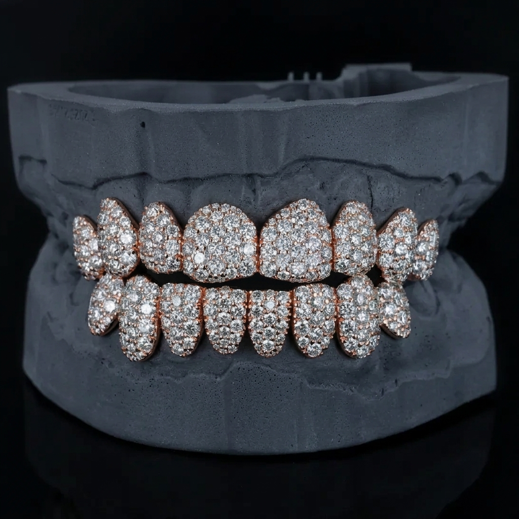 Rose gold moissanite grillz full set on a dark gray dental mold, front view of iced out top and bottom teeth