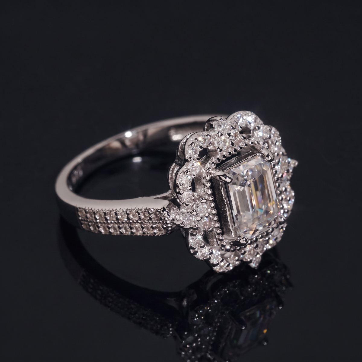 Emerald cut moissanite vintage halo ring side angle showing double row pave shoulders