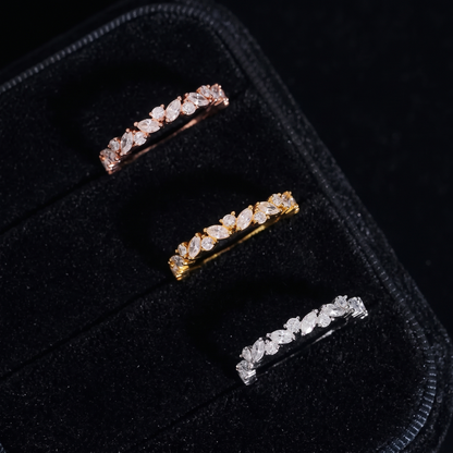 Marquise moissanite stackable eternity bands in rose gold, gold and silver on black velvet tray