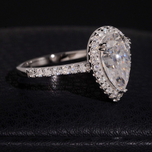 Pear cut moissanite ring side view showing halo and pave band