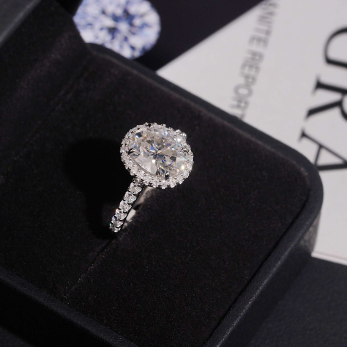 Oval moissanite halo ring in ring box