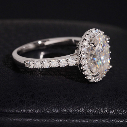 Oval moissanite ring side view showing halo and pave band