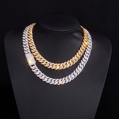 Gold and silver iced out 3 row cuban link chains layered on jewelry display bust