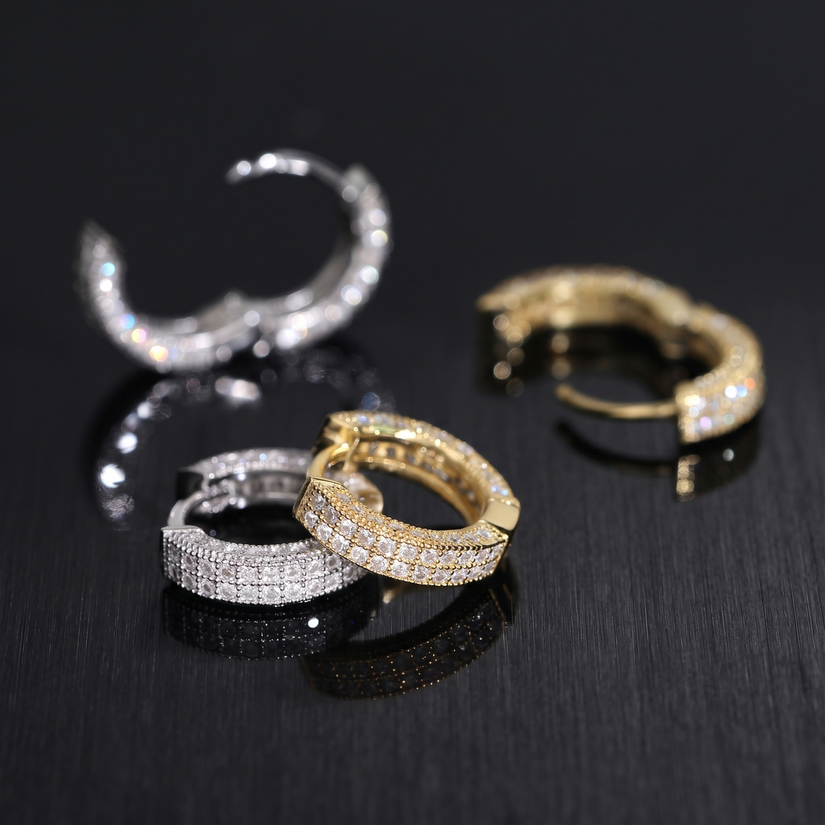 Detail of the two pave rows and milgrain edging on the moissanite huggie hoops